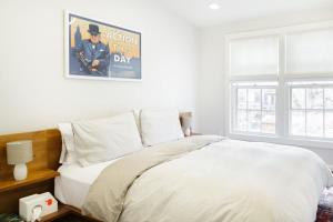 a bedroom with a bed with a poster on the wall at Historic Charming Home in Old Town in Alexandria