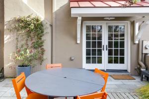 a white table and chairs in front of a house at Historic Charming Home in Old Town in Alexandria