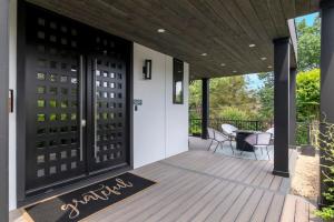 a screened porch with black doors and a table at Top of The Hill Luxury Clarendon 4-BR Homestay in Arlington