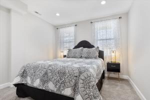 巴尔的摩Charm City Homestay in Washington Village的带一张床和两扇窗户的卧室