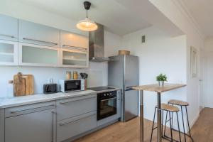 a kitchen with stainless steel appliances and a table at One bedroom apartment with balcony, city center in Tourcoing