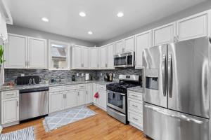 a kitchen with white cabinets and stainless steel appliances at Short Drive to Capitol Hill-Convenient MD Homestay in Capitol Heights