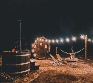 a night scene with a wooden barrel and a playground at Barrel Land Blidinje - Drvena bačva za spavanje in Posušje