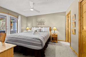 a bedroom with a large bed and a window at Crystal Forest #51 condo in Sun Peaks