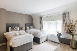 a bedroom with two beds and a window at Flat in Guildford in Stoughton