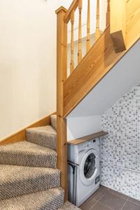 a staircase with a washing machine under a stair case at Flat in Guildford in Stoughton