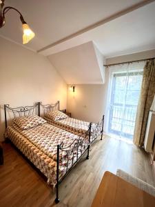 a bedroom with a bed and a large window at Willa Na Krańcu Kazimierza in Uściąż