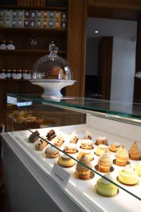 a display case filled with different types of pastries at Le Moulin Des Ruats in Avallon