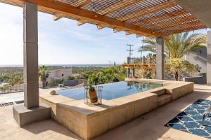 an outdoor swimming pool with a pergola at Near Downtown w Views of Marina Puerto Los Cabos in La Choya