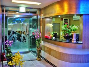 a lobby with a bunch of potted plants at City Park Hotel in Seoul