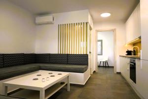 a living room with a couch and a table at Bluewave Lux house in Ornos
