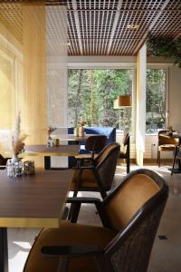 a living room with a couch and a table and chairs at Le Moulin Des Ruats in Avallon