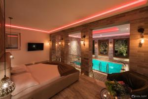 a living room with a bed and a swimming pool at Vera HOTEL-VILLA in Pristina