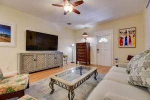a living room with a couch and a tv at The Mesa House-Close to Duval! in Key West