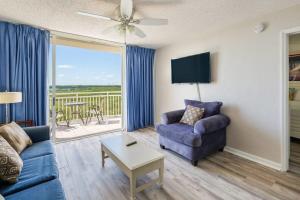 a living room with a couch and a table at The Andros by Brightwild-4th Floor Sunset View in Key West