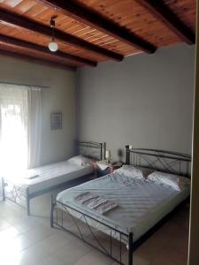 a bedroom with two beds and a window at ''Venus'' in Agios Vlasios