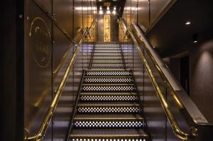 an escalator leading up to an elevator in a building at Hotel Gotham in Manchester