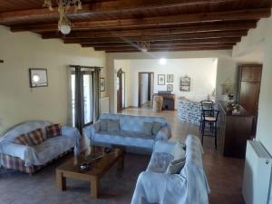 a large living room with couches and a table at Venus cottage in Agios Vlasios