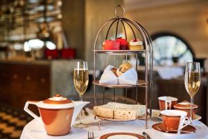 a table with a tray of food and glasses of wine at Hotel Gotham in Manchester