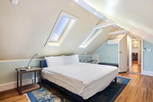 a bedroom with a bed and two skylights at Sky Loft in Key West by Brightwild in Key West