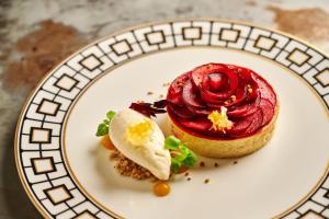 a white plate with a dessert on a table at Hotel Gotham in Manchester