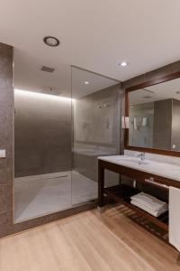 een badkamer met een glazen douche en een wastafel bij Magnolia Hotel - Adults Only in Salou