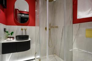 a bathroom with a shower and a mirror at Hotel Poli Urban in Tel Aviv