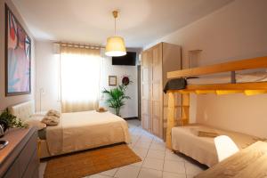 a bedroom with two bunk beds and a window at B&B La Volpina in Rimini