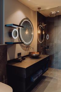 a bathroom with a sink and a mirror at THE MATTHEW - pop up & down in Wagrain