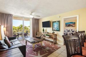 a living room with a couch and a table at The Exuma Cay by Brightwild-Pool View & Parking in Key West