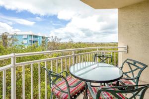 a patio table and chairs on a balcony at The Tortuga by Brightwild-Pool, Parking & Pets! in Key West