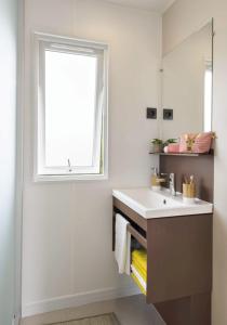 a bathroom with a sink and a window at Camping LES PEUPLIERS in Hyères