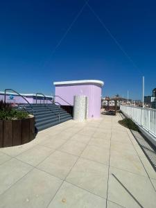 a purple building with stairs and a blue sky at Marina Club Luxury private studio with Pool and incredible views in Gibraltar
