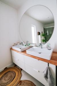 a bathroom with two sinks and a mirror at Dwa Słowa in Giżycko