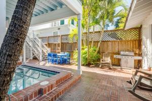 a backyard with a swimming pool and a table and chairs at Creme Brulee Suite by Brightwild in Key West