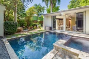 a swimming pool in front of a house at Contra House by Brightwild-Luxury Home With Pool in Key West