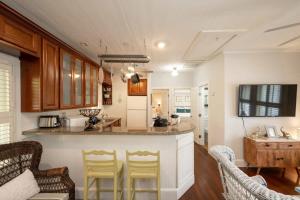 a kitchen with a counter and chairs in a room at The Conch by Brightwild-Pool & Quiet Area in Key West