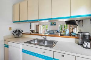 a kitchen with a sink and a counter top at Sunnyside Up in Key West +25 photos