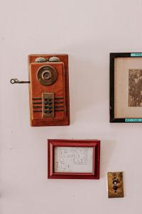 an old radio is hanging on a wall at King Suite Balcony by Brightwild- at James House in Key West