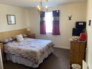 a bedroom with a bed and a window at The Jolly Drayman Pub and Hotel in Gravesend