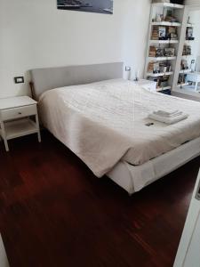 a bedroom with a large bed and a wooden floor at Room-Apartment 300 meters from the RACETRACK in Imola