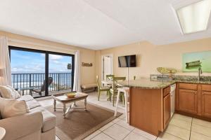 a kitchen and living room with a view of the ocean at Oceanfront Condo with Amazing Views! Sunglow Resort 902 by Brightwild in Daytona Beach Shores