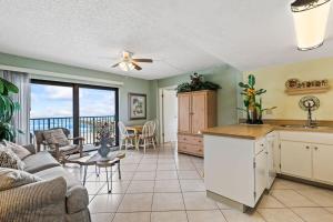 a kitchen and living room with a couch and a table at Ocean Front Condo with Amazing Views! Sunglow Resort 402 by Brightwild in Daytona Beach Shores