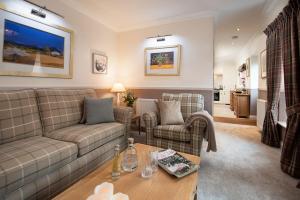 a living room with a couch and a table at Eildon View in Melrose