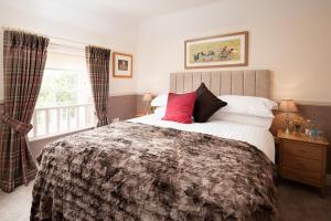 a bedroom with a large bed and a window at Eildon View in Melrose