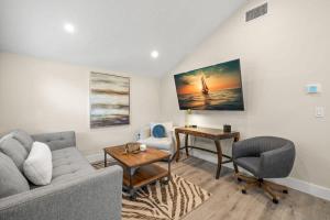 a living room with a couch and a table at NEW! SoHo Suite, Steps to S Howard Ave in Tampa