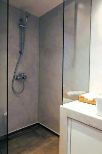 a shower with a glass door in a bathroom at Bluewave Lux house in Ornos +18 photos