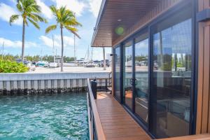 a house with a swimming pool next to a building at Awai's Floating Villa - Houseboat in Luxury Village in Key West