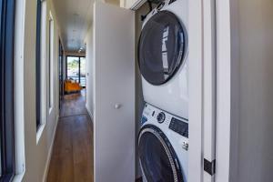 a washer and dryer in a hallway of a house at Awai's Floating Villa - Houseboat in Luxury Village in Key West