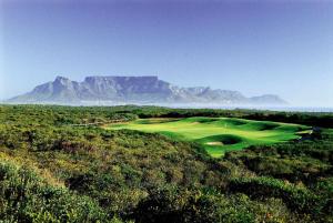 a golf course with a mountain in the background at Sea Breeze Cottage in Cape Town